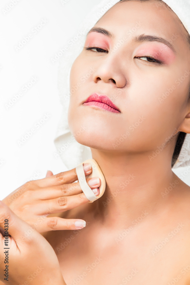 woman applying powder on her neck woman applying powder on her neck