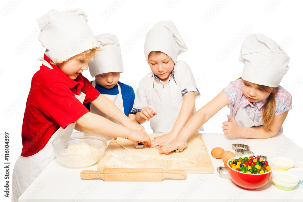 Happy bakers making cookies with cookie cutters Happy bakers making cookies with cookie cutters
