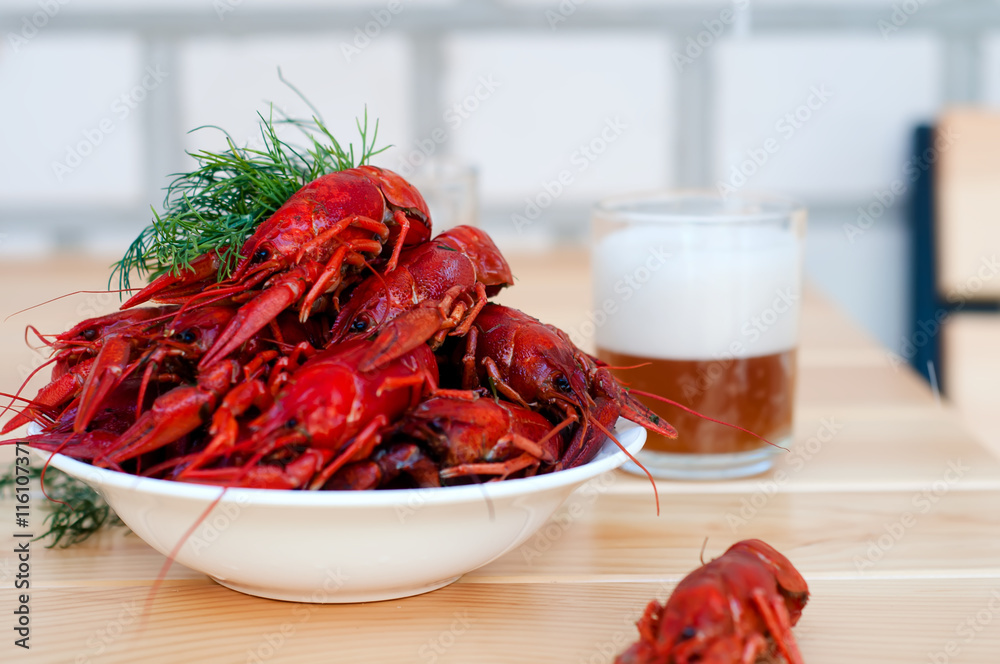 Boiled crayfishes with greenery on a plate Boiled crayfishes with greenery on a plate