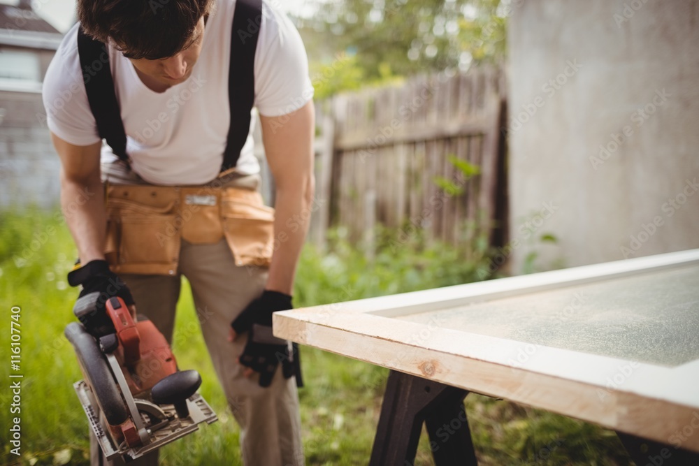 Carpenter working with circular saw Carpenter working with circular saw