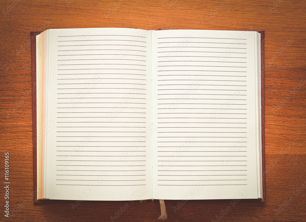 open notebook on a wooden table open notebook on a wooden table