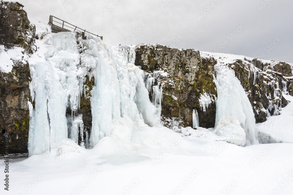 Amazing Kirkjufell frozen waterfall in winter. Iceland