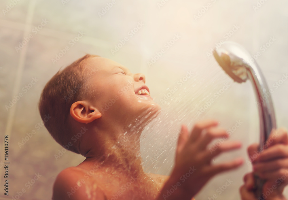 Portrait of cute  boy having shower with eyes closed - obrazy, fototapety, plakaty 