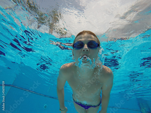boy diving into a swimming pool
