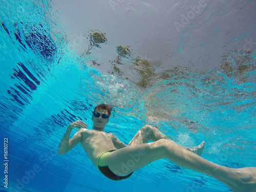 boy diving into a swimming pool