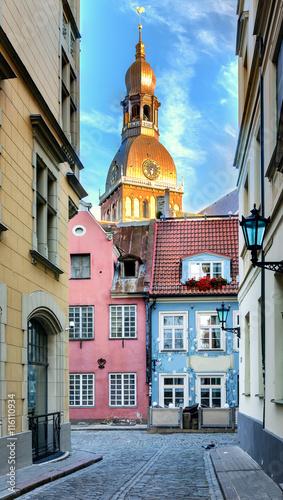 Narrow street with a view on the biggest building of Dome church in old Riga ...