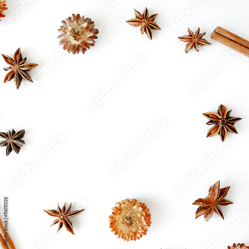 dry flowers, cinnamon and cardamom round frame wreath pattern on white background. flat lay, top view