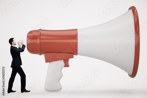 Man screaming into loudspeaker photo