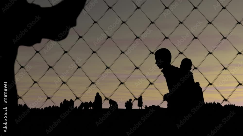 Refugees. Migrants behind barbed wire.