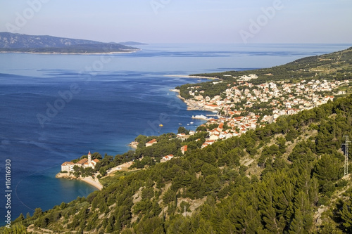 Touristic village Bol on Brac island with Dominican Monastery in front, and famous beach Golden cape on background