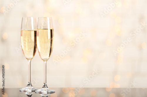 Vászonkép Two champagne glasses on light background