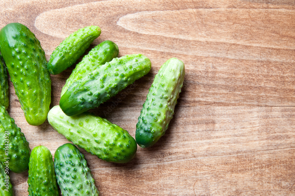 The image of fresh cucumber on a wooden table The image of fresh cucumber on a wooden table