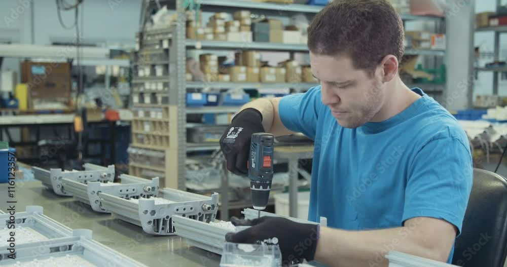 Worker in a LED lamps production line