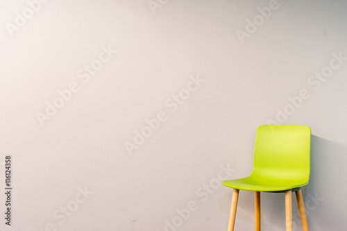 Fototapeta Naklejka Na Ścianę i Meble -  Single modern chair by the wall