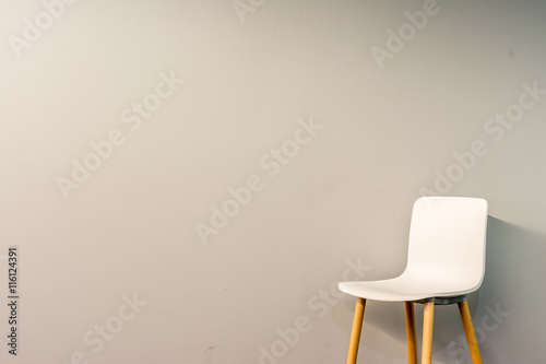 Single modern chair by the wall