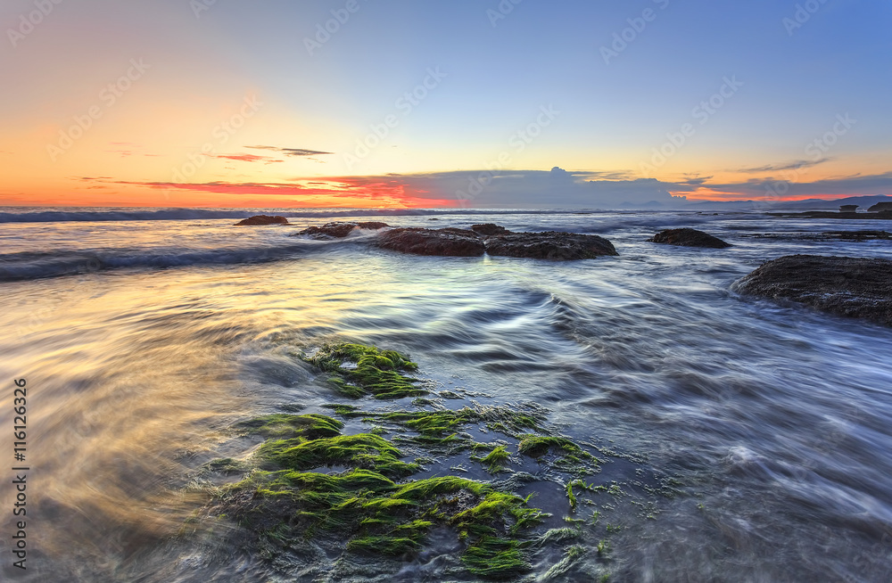 Waves & Mossy of Tanah Lot beach at sunset in bali indonesia for background