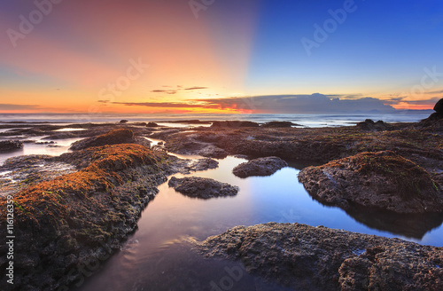 Beautiful vibrant seascape at sunset of Tanah Lot beach in bali, indonesia