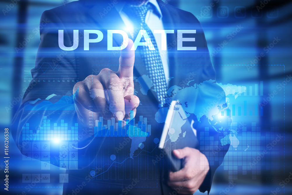 Obraz premium Businessman is pressing on the virtual screen and selecting Update.