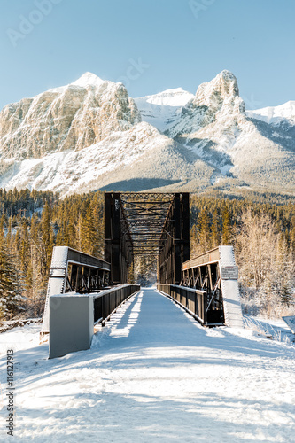 bridge over a frozen river, canmore, banff, national park, alberta, canada photo