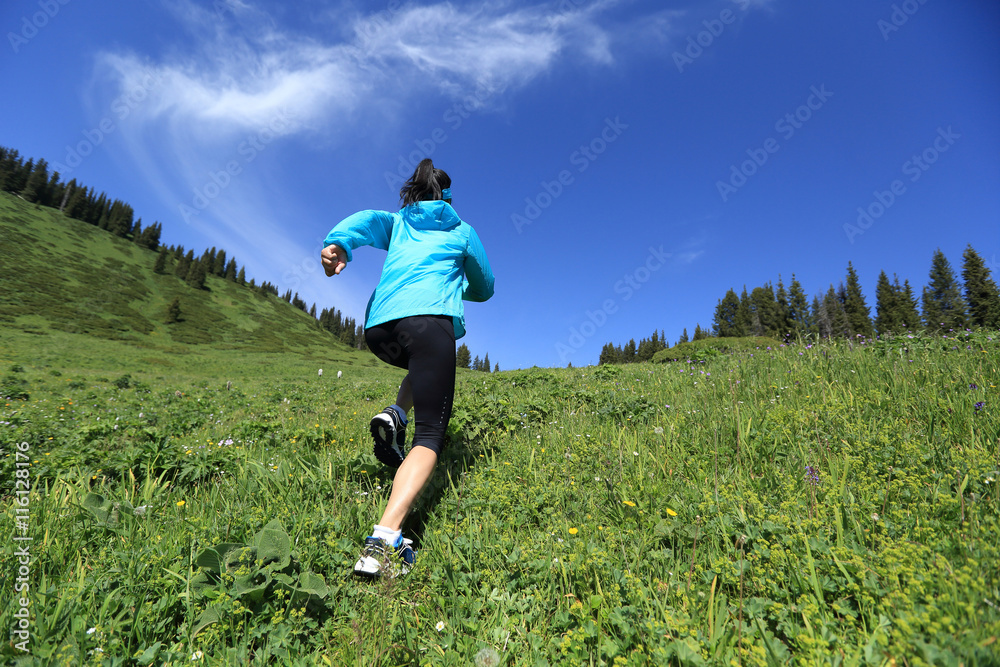 healthy young woman trail runner running on beautiful mountain peak healthy young woman trail runner running on beautiful mountain peak