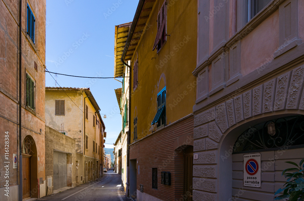 Narrow European town street with sea view. No Parking sign in Italian. Orbetello, Italy