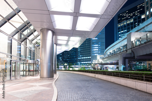 Wall Mural modern office buildings in downtown of tokyo from empty footpath