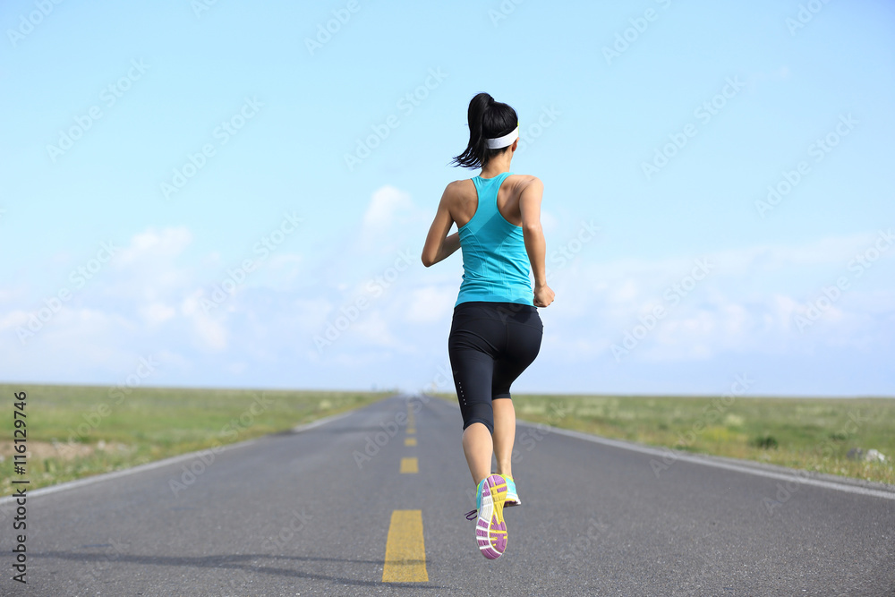 young fitness woman runner running on road