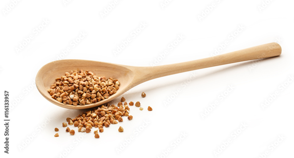 Wooden spoon with dry buckwheat
