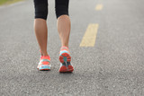 young fitness woman runner running on road