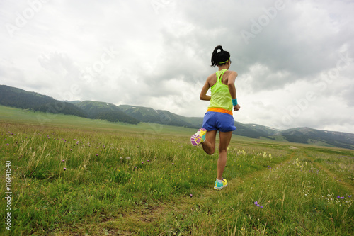 healthy lifestyle young woman runner running on beautiful road