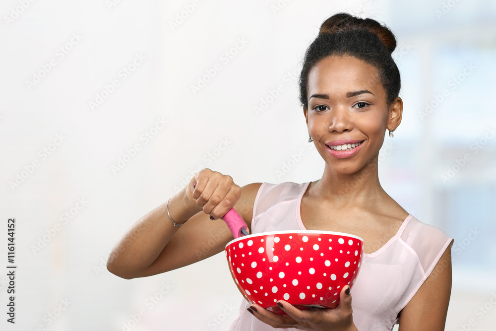 African american woman holding kitchen utensils African american woman holding kitchen utensils