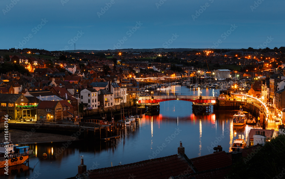 WHITBY, ENGLAND - JULY 16: The swing bridge within Whitby harbour, at night. In Whitby, North Yorkshire, England. On 16th July 2016.