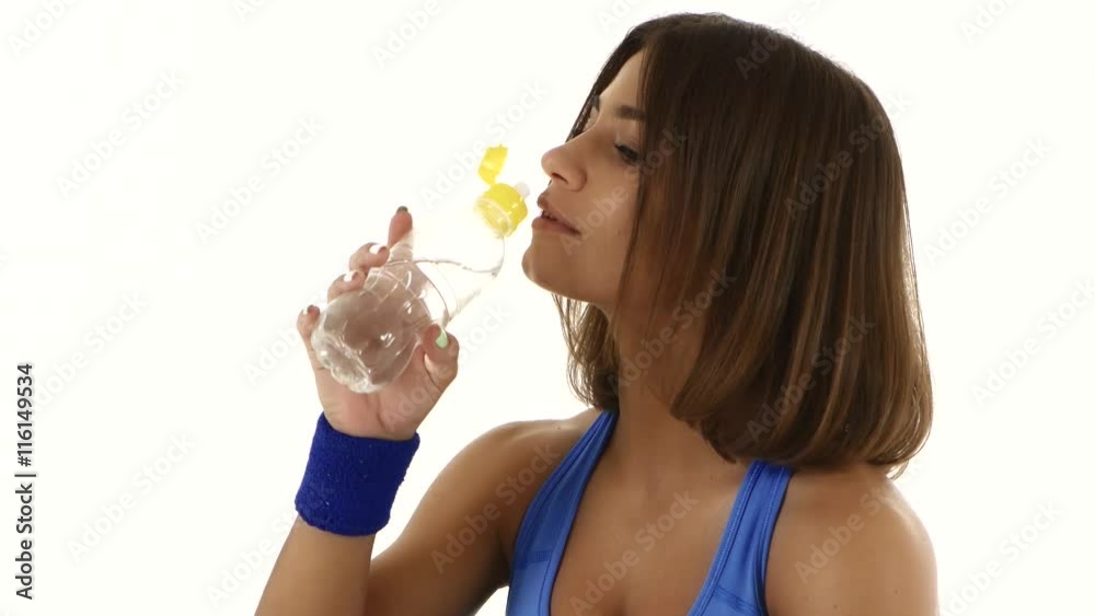 Athlete drinks water during a workout. Close up. White Athlete drinks water during a workout. Close up. White