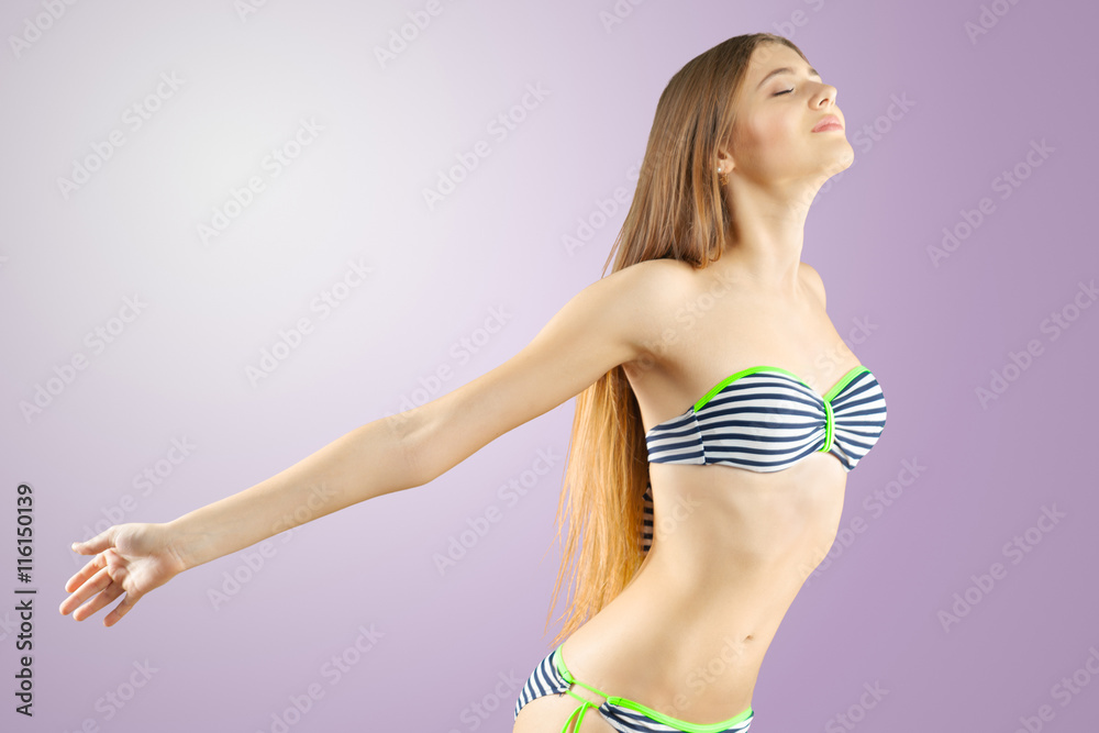 Obraz premium Blonde girl in striped bikini