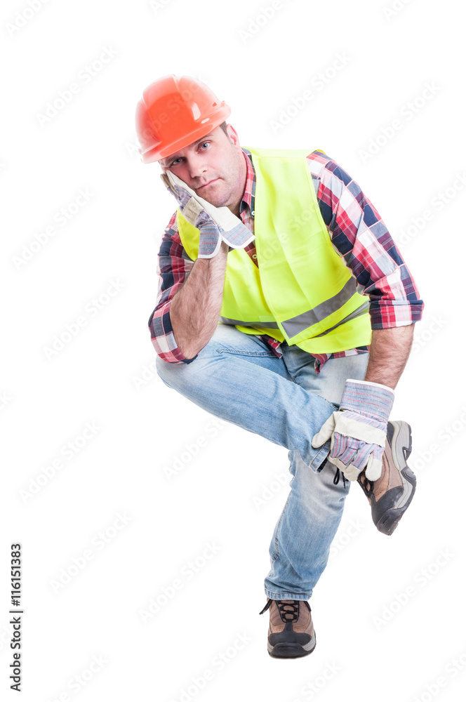Thoughtful constructor sitting on something and looking dissapoi Thoughtful constructor sitting on something and looking dissapoi