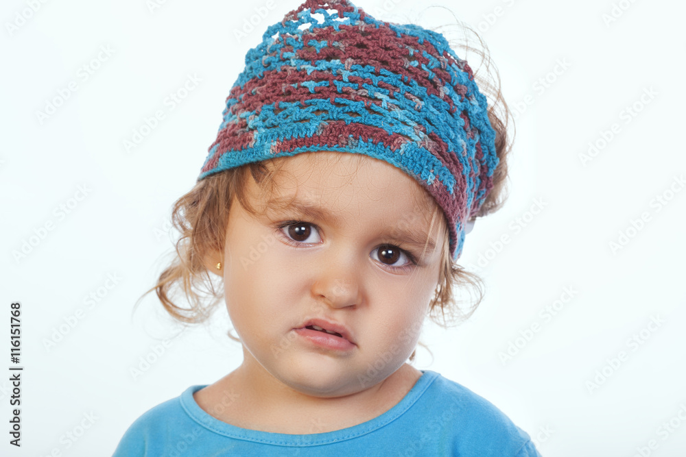 Bored little kid in handmade headband looking at camera Bored little kid in handmade headband looking at camera