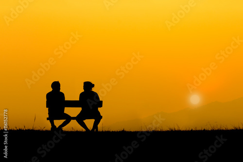 A silhouette of sweetheart on the bench in sunset © OkayStocker