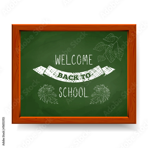 Welcome back to school text written in chalk on green blackboard