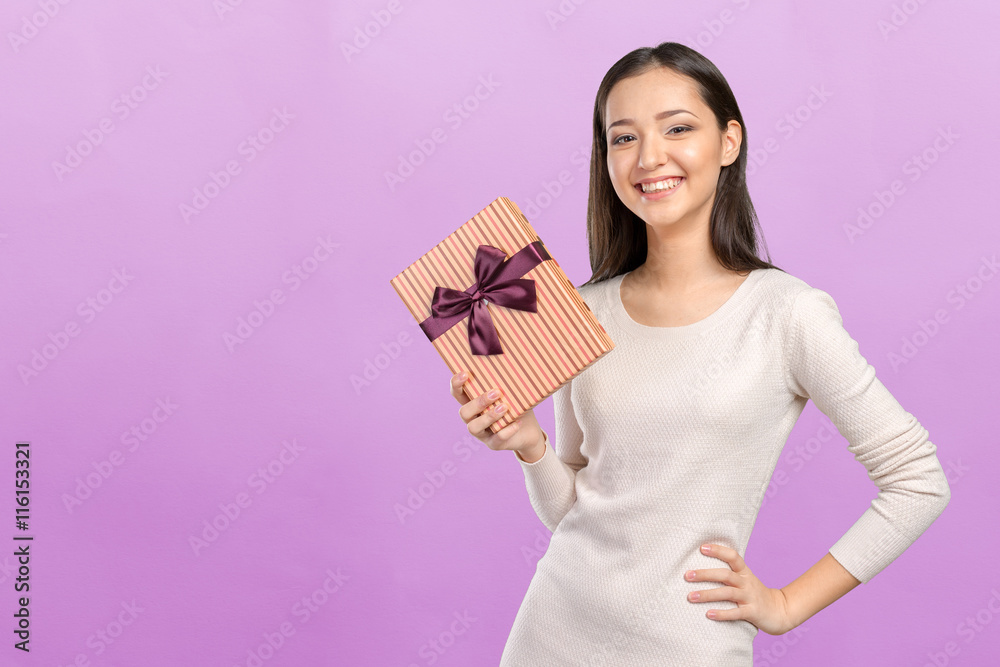Beautiful smiling woman with long hair holding gift box Beautiful smiling woman with long hair holding gift box
