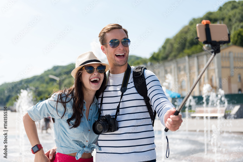 Overjoyed happy couple making selfies
