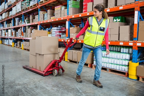 Foto Worker pushing trolley with boxes