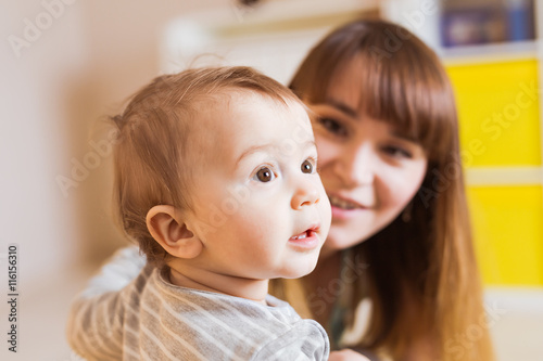 Portrait of happy mother and baby at home