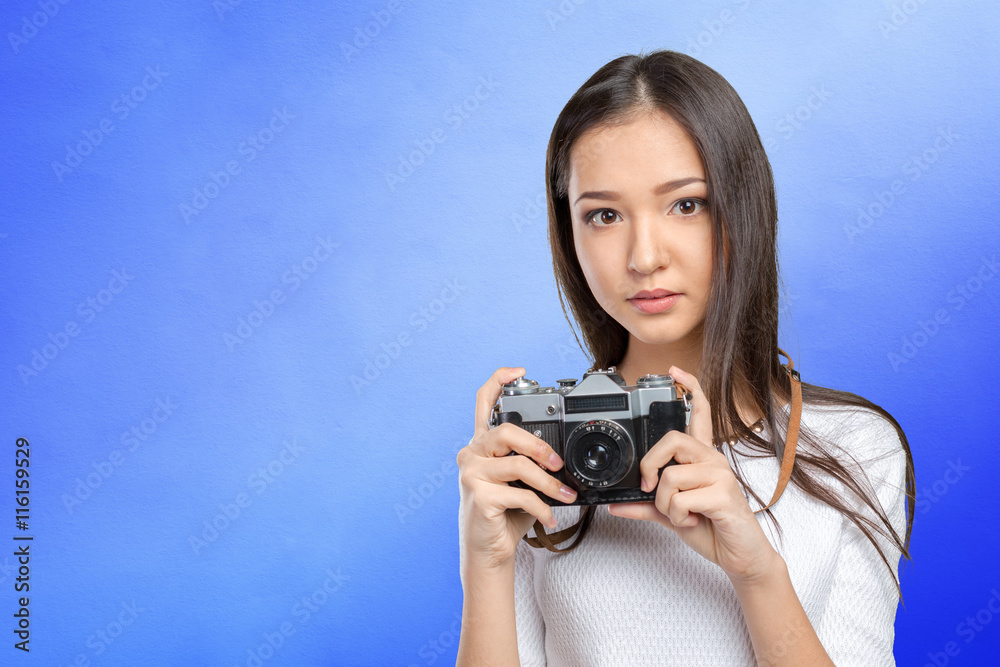 Woman using a retro photo camera Woman using a retro photo camera