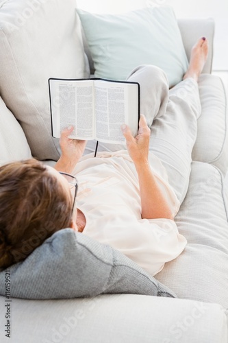 Full length of mature woman reading book