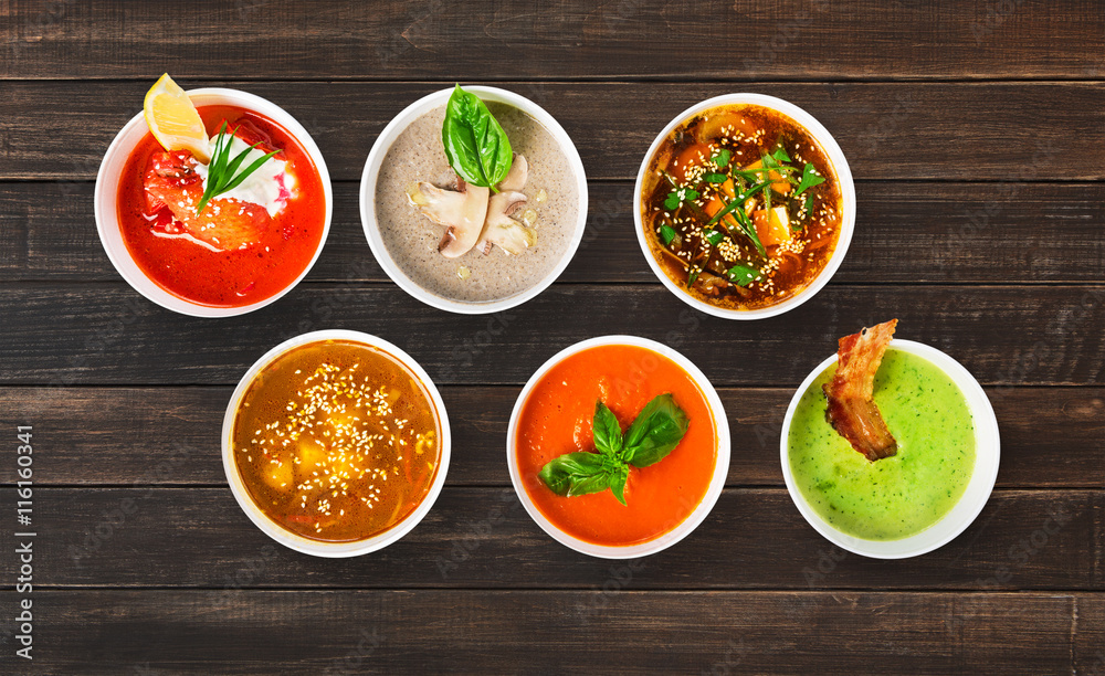 Variety of soups at brown wood, top view Variety of soups at brown wood, top view