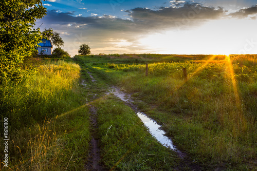 The road to the farmer's lodge, rural road at sunset © mrzazaz