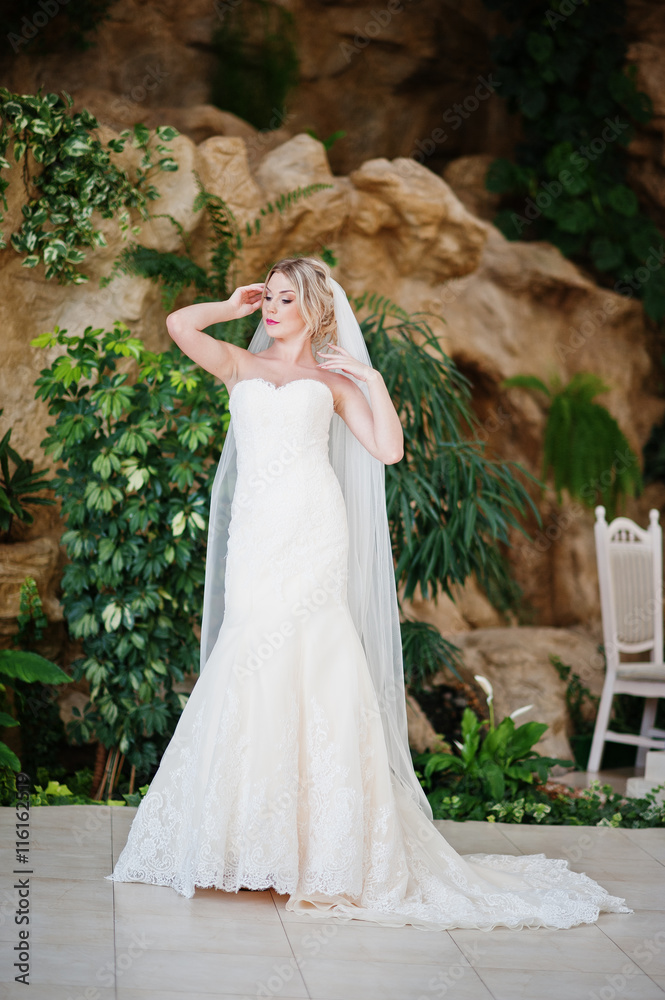 Gorgeous blonde bride posed at great awesome wedding hall