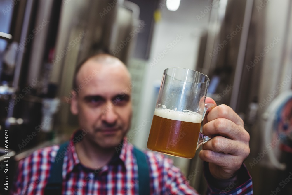 Manufacturer looking at beer mug