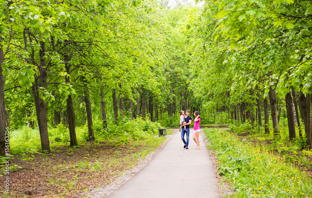 Happy young family spending time together outside in green nature. Happy young family spending time together outside in green nature.