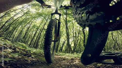 Mountain bike POV riding through a forest. Wide angle. photo